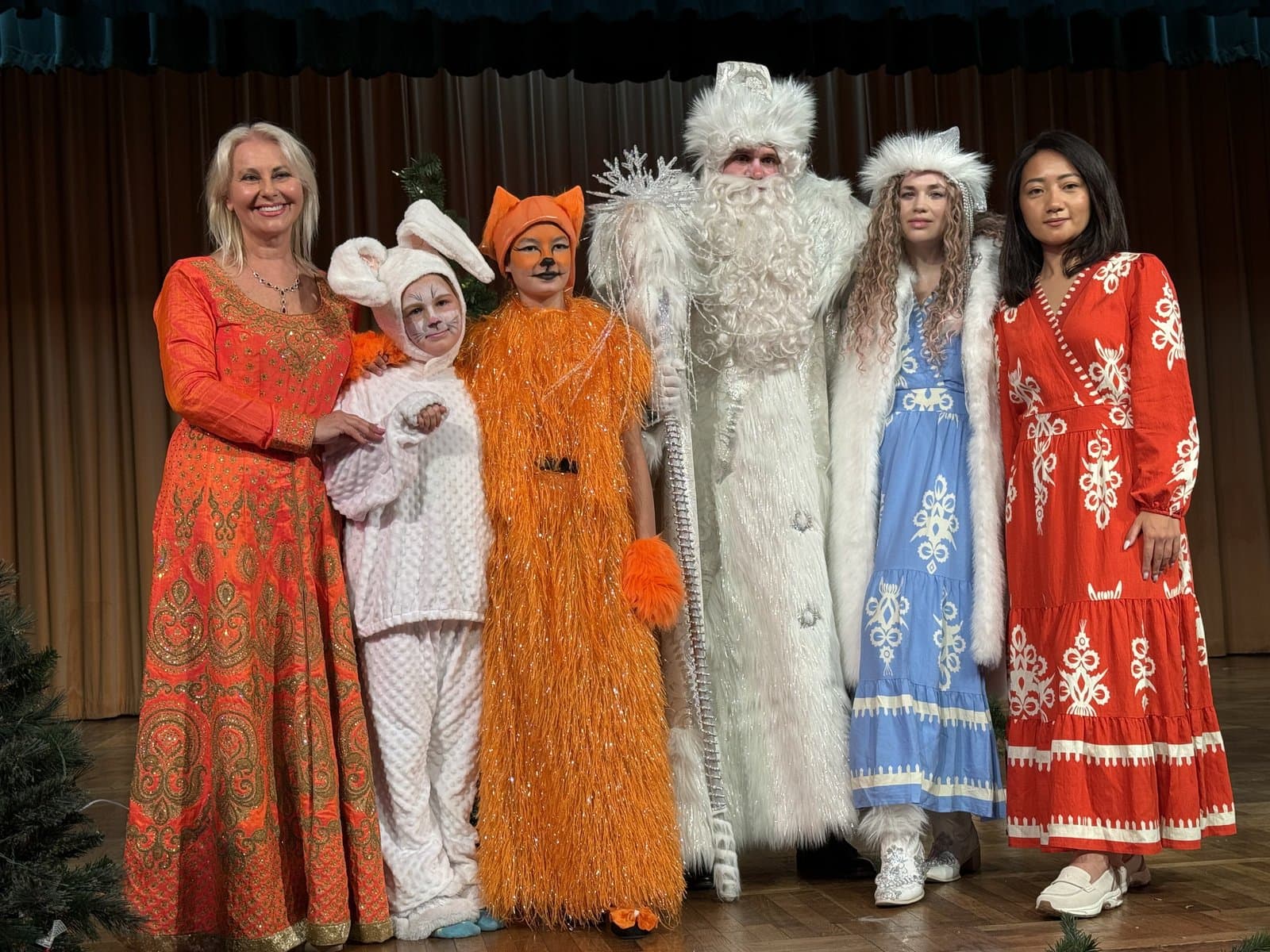 Miss Lana and the costumed troupe together on stage after a fairy-tale show.